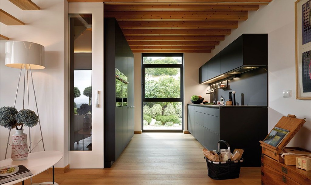 Black kitchen open to the living room