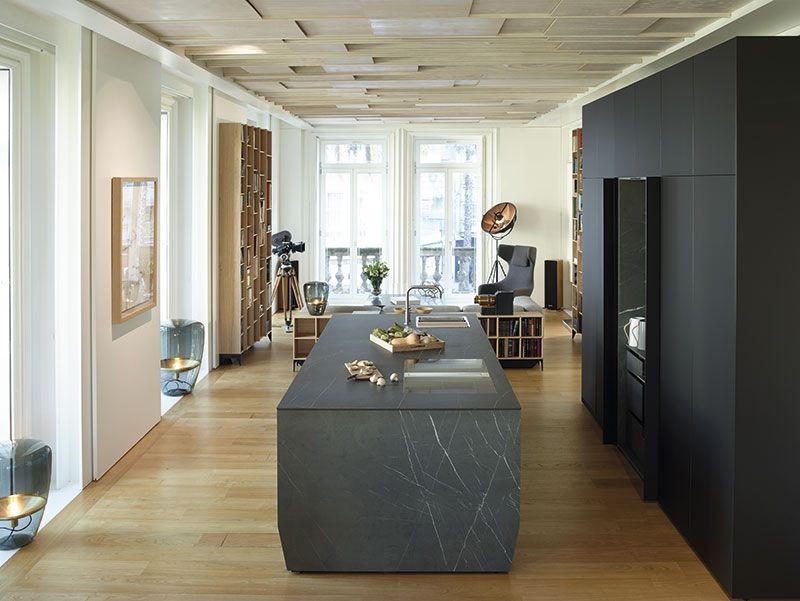 Black open kitchen surrounded by neutral tones