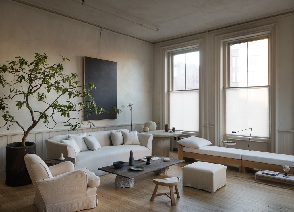 Neutral living room with a white sofa and indoor tree