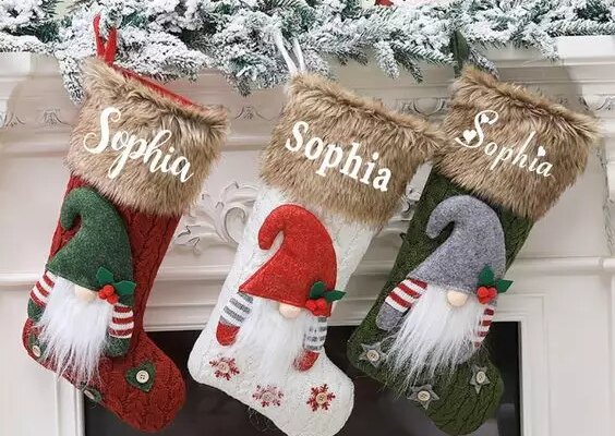 Socks hanging next to a Christmas fireplace