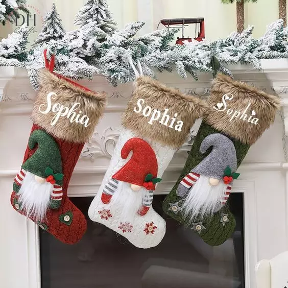 Socks hanging next to a Christmas fireplace